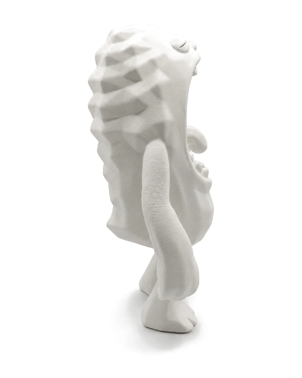 The creature from the other side, the faceted ridges catching light along its spine